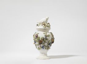 A faience vase with a bird finial