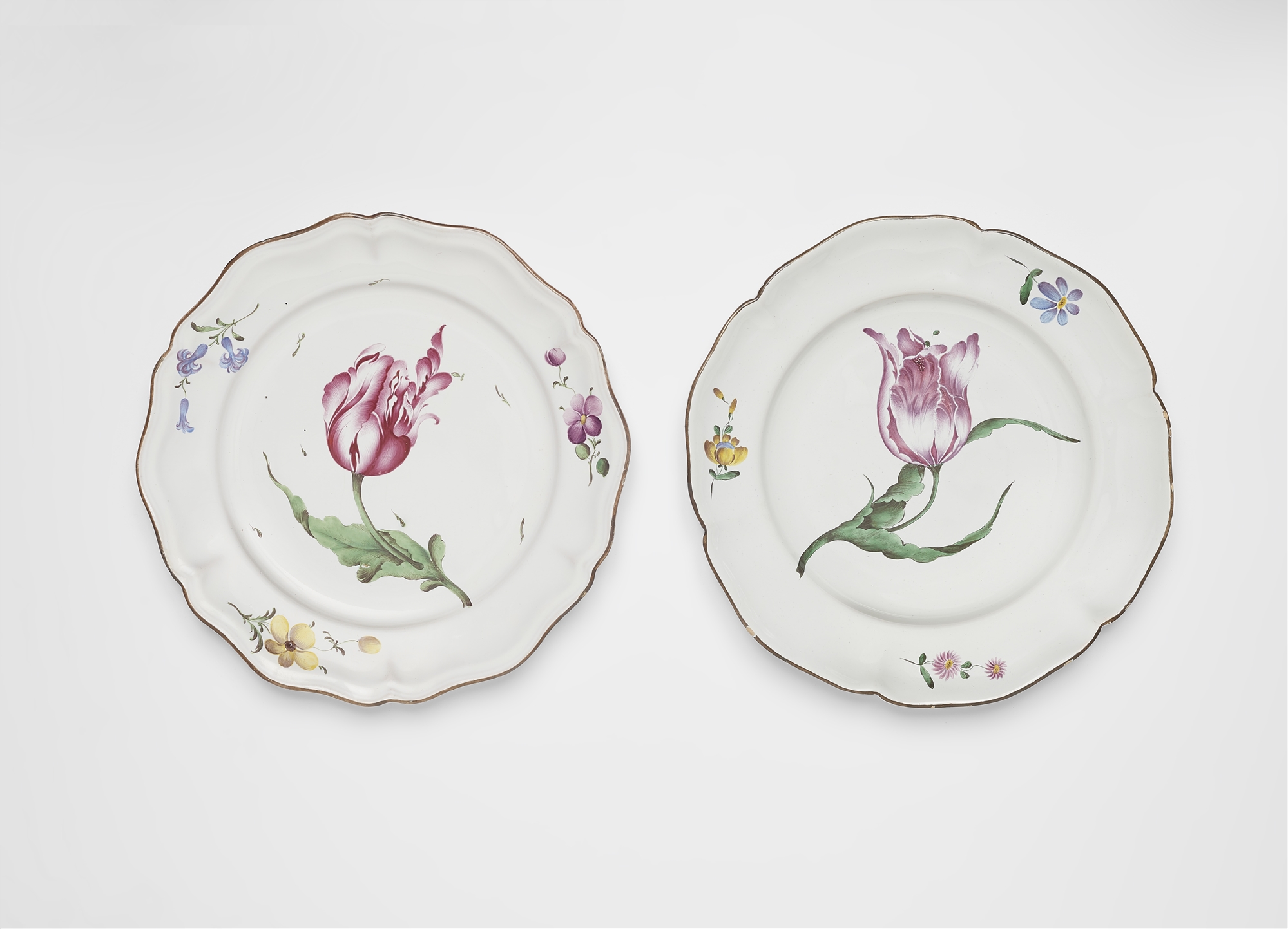 A round Strasbourg faience platter and two plates with 'fleurs esseulées' - Image 2 of 3
