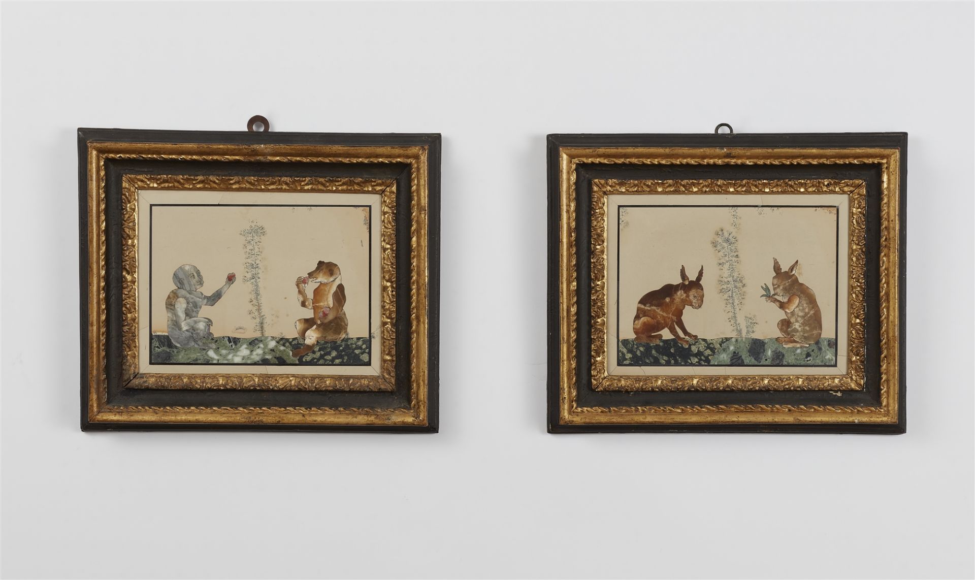 A pair of inlaid stone panels with surreal animal motifs