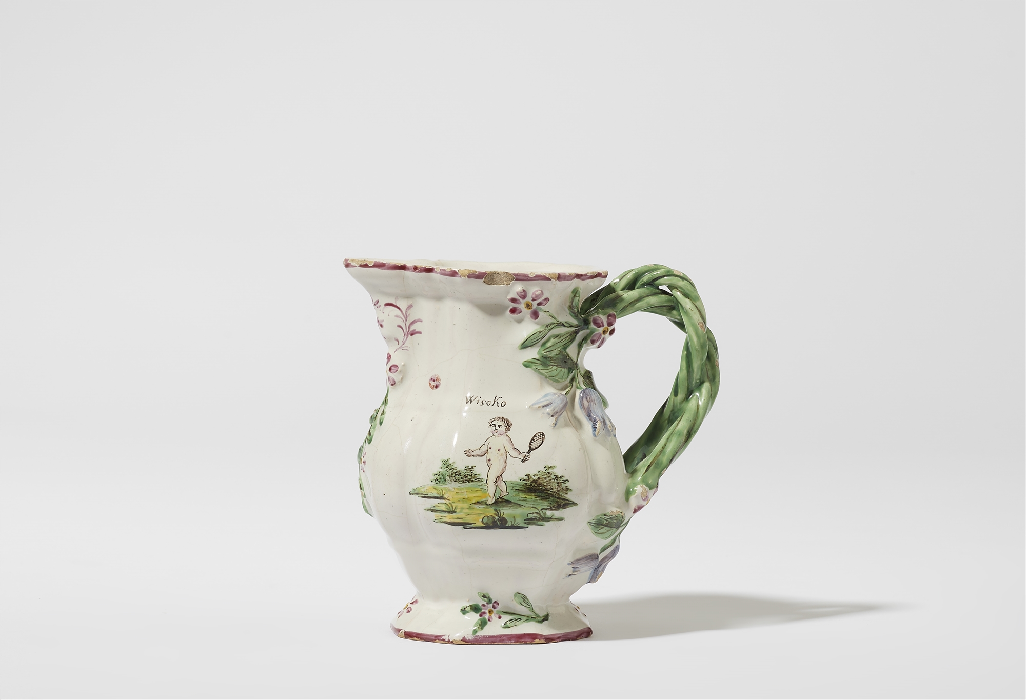 A Proskau faience jug with putti playing tennis