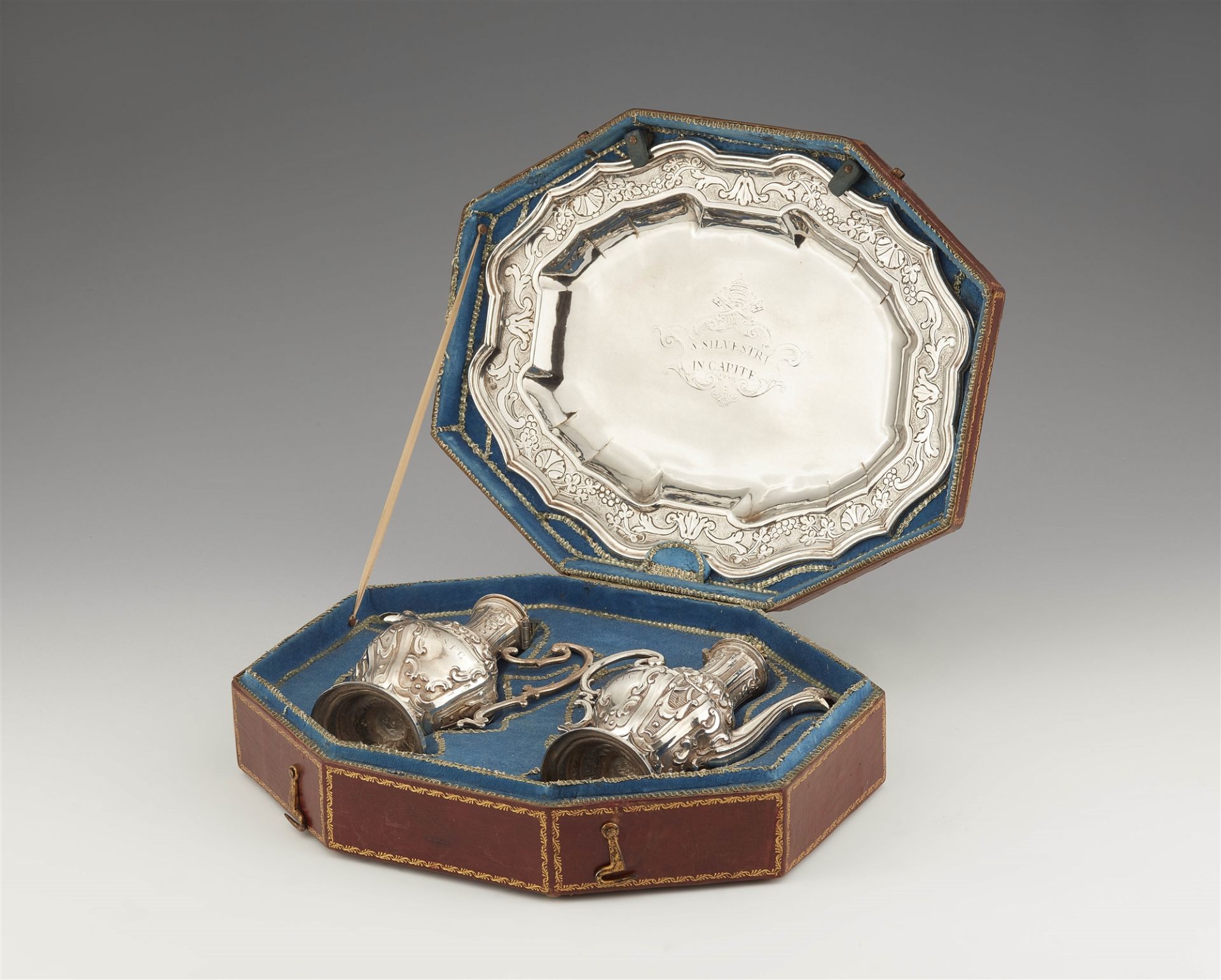 A parcel gilt Roman silver communion garniture in a fitted leather case