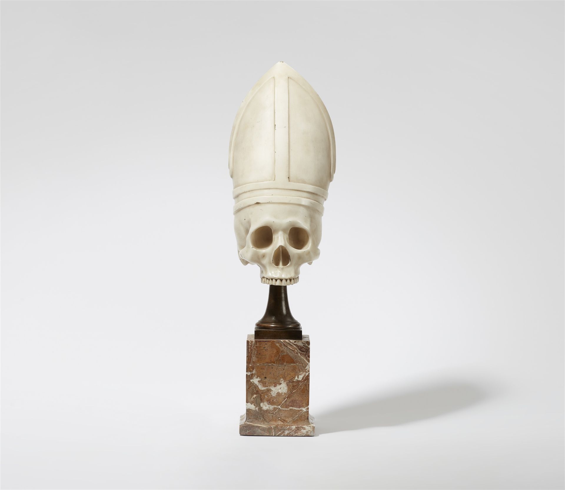 A white marble skull wearing a mitre