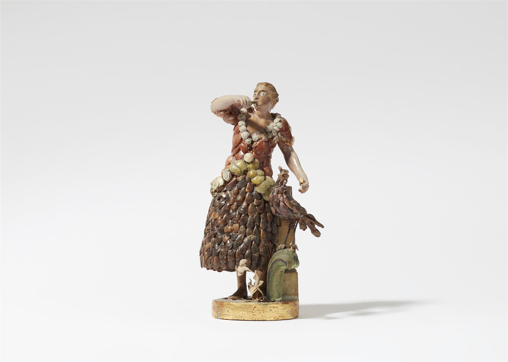 A figure of a lady playing the flute with a bird