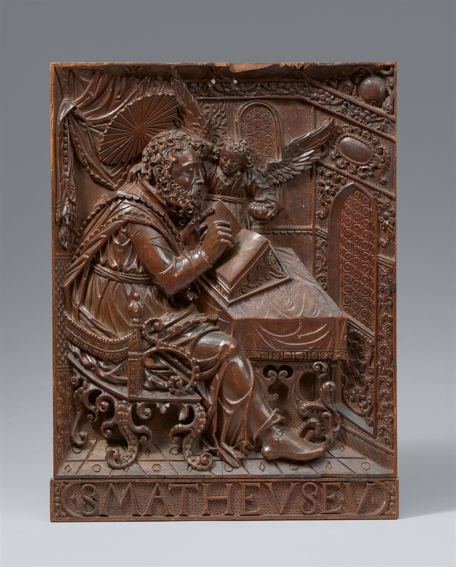 A carved wood relief of St Matthew, Bavaria, 1st quarter 17th century