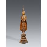 A large and slender Ratanakosin gilded and lacquered bronze figure of a crowned and bejeweled Buddha