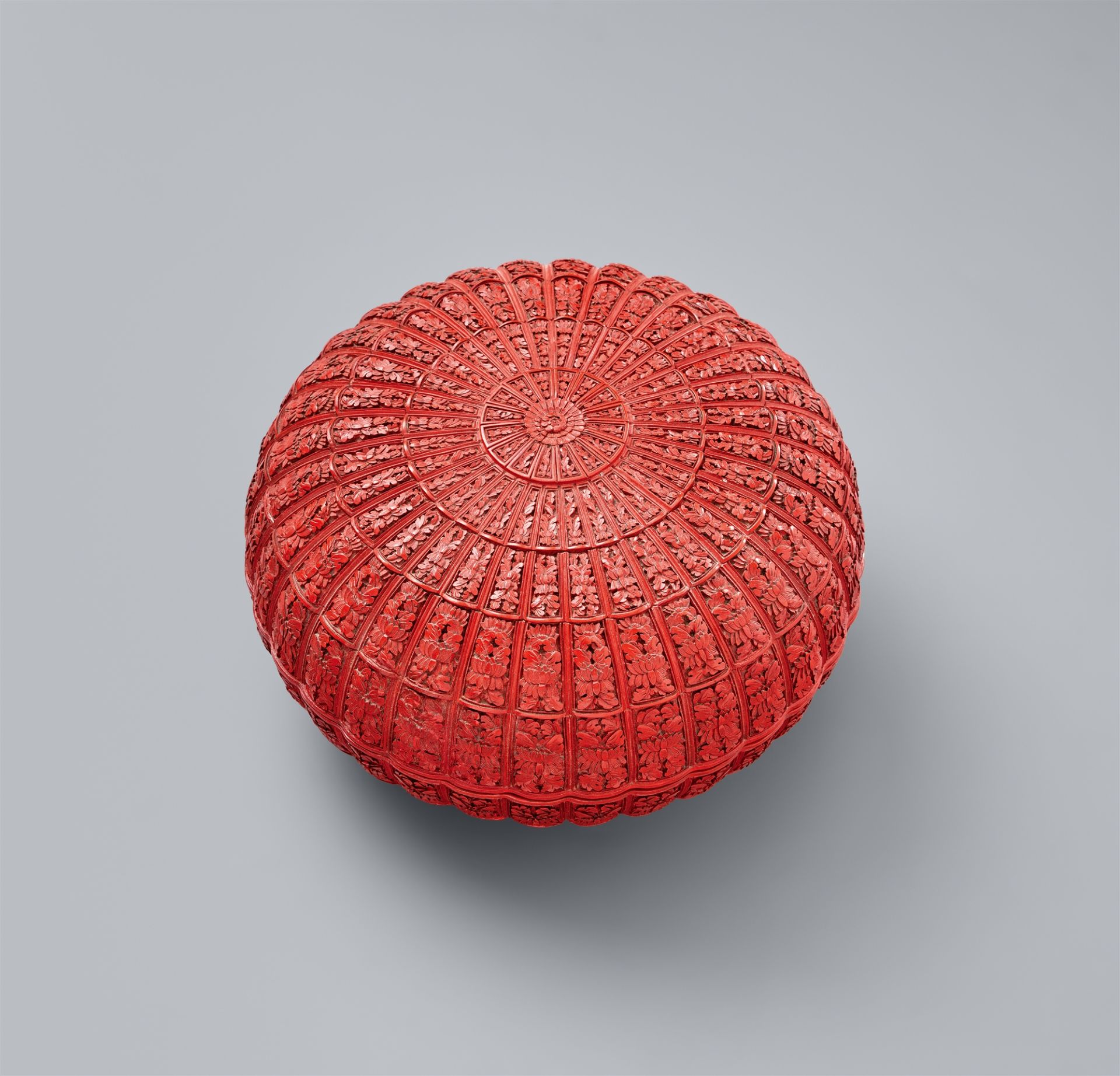 A cinnabar carved lacquer chrysanthemum-shaped box and cover. Qing dynasty, 18th century