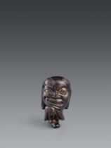 A lacquered wood netsuke of a bakemono. 19th century