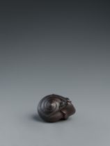 A dark stained boxwood netsuke of a snail. Nagoya. Mid-19th century