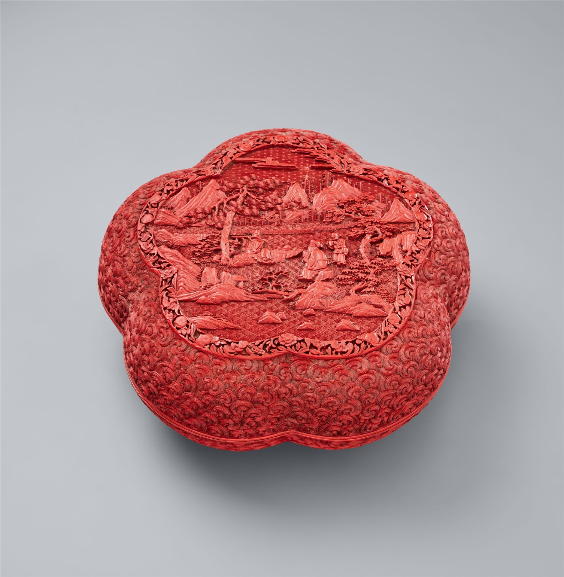 A cinnabar carved lacquer box and cover. 18th century