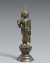 A Singhalese bronze figure of a standing Buddha. Late Kandya period (1480-1815)