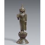 A Singhalese bronze figure of a standing Buddha. Late Kandya period (1480-1815)