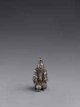 A silver netsuke of courtier playing foot ball. 19th century