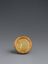 A gold and lacquered wood kagamibuta netsuke. Mid 19th century