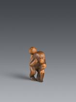 A boxwood netsuke of a monkey with a large gourd. Late 19th century