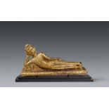 An Ayutthaya gilded and lacquered bronze figure of a reclining Buddha. Thailand. 18th/19th century