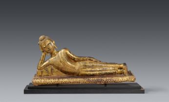 An Ayutthaya gilded and lacquered bronze figure of a reclining Buddha. Thailand. 18th/19th century