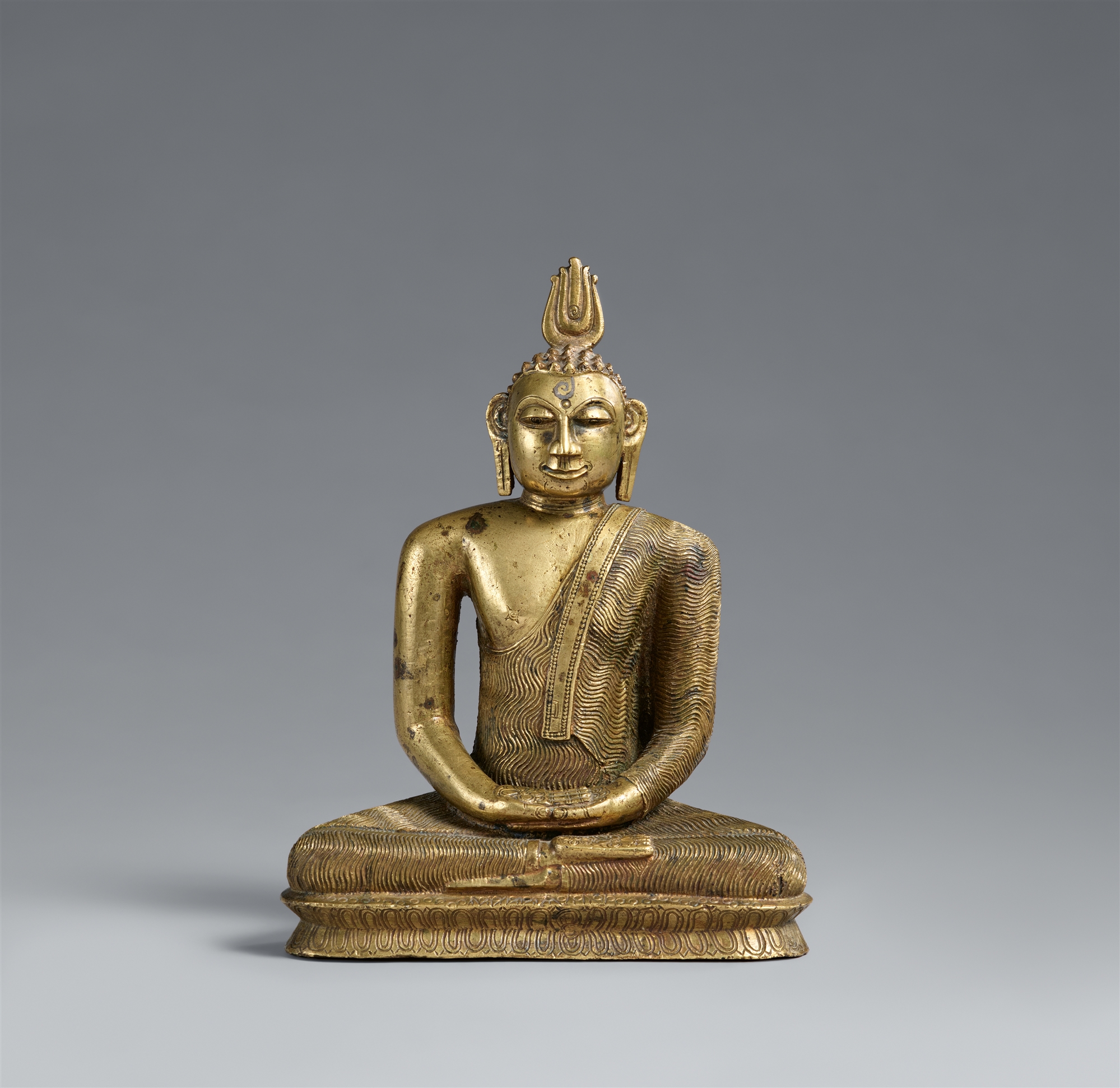 A Singhalese copper alloy figure of Buddha Shakyamuni. Late Kandya period (1480-1815)