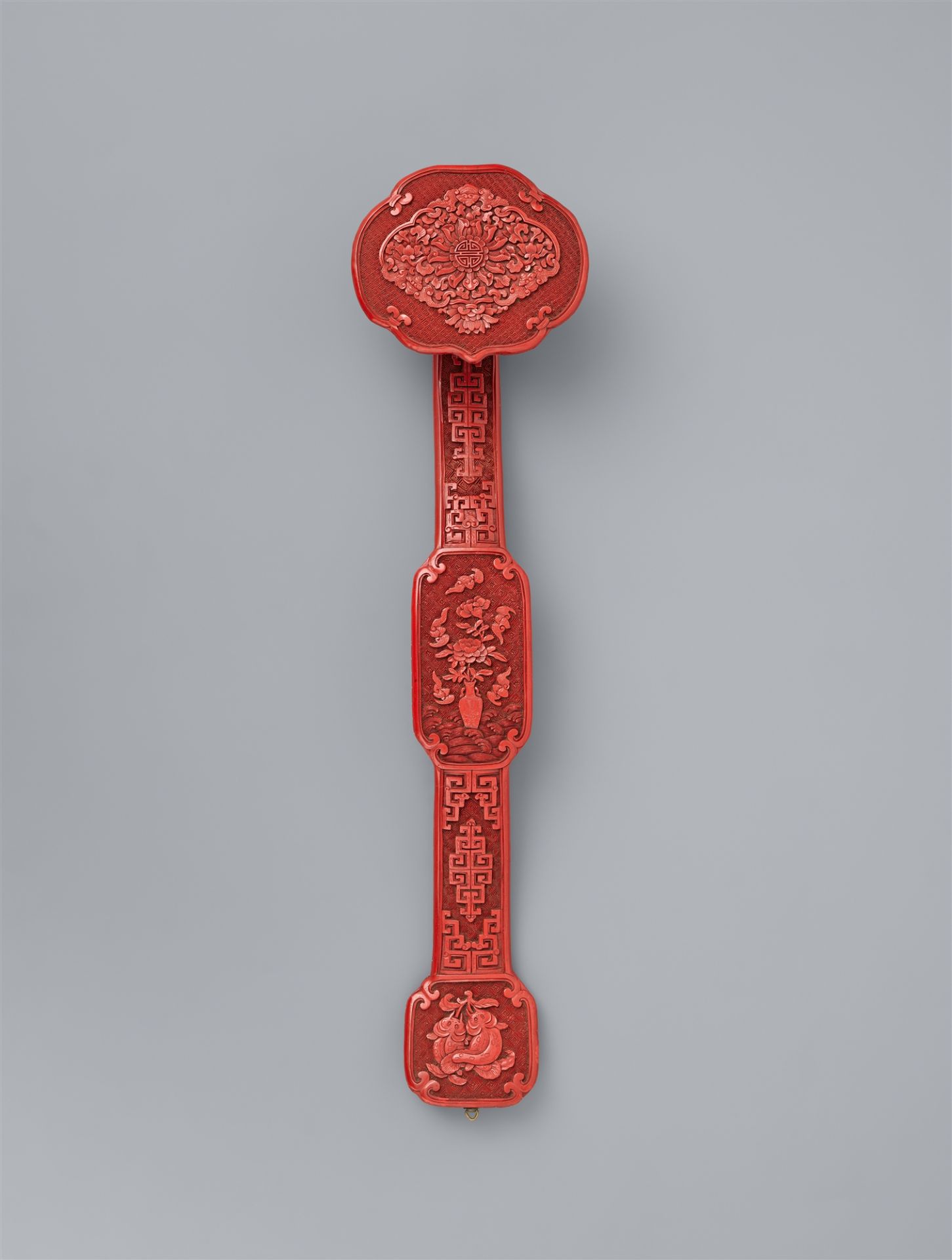 A cinnabar carved lacquer ruyi sceptre. Late Qing dynasty