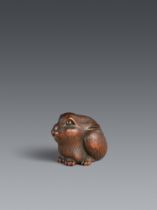 A wood netsuke of seated hare.