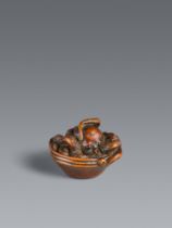 A very fine boxwood netsuke of an octopus in a suribachi. 19th century