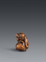 A powerful boxwood netsuke of Shōki capturing an oni. 18th century