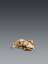 An ivory netsuke of a recumbent ox and a little boy. Late 18th century