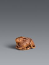 A boxwood netsuke of a reclining long-haired goat. Probably Tsu. First half 19th century