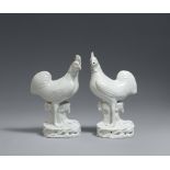A pair of Dehua cockerel figures. Qing dynasty, 18th century