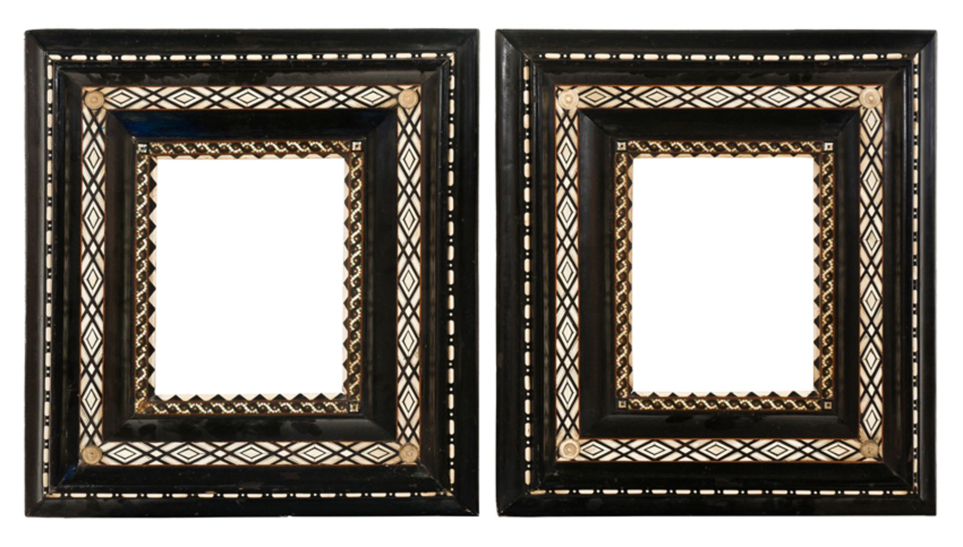 Pair of imposing carved, ebonised wooden frames with applications of bone and stained bone. Venice.