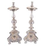 Pair of carved, embossed and chiselled silver candlesticks punched with the &quot;MAS&quot; mark by