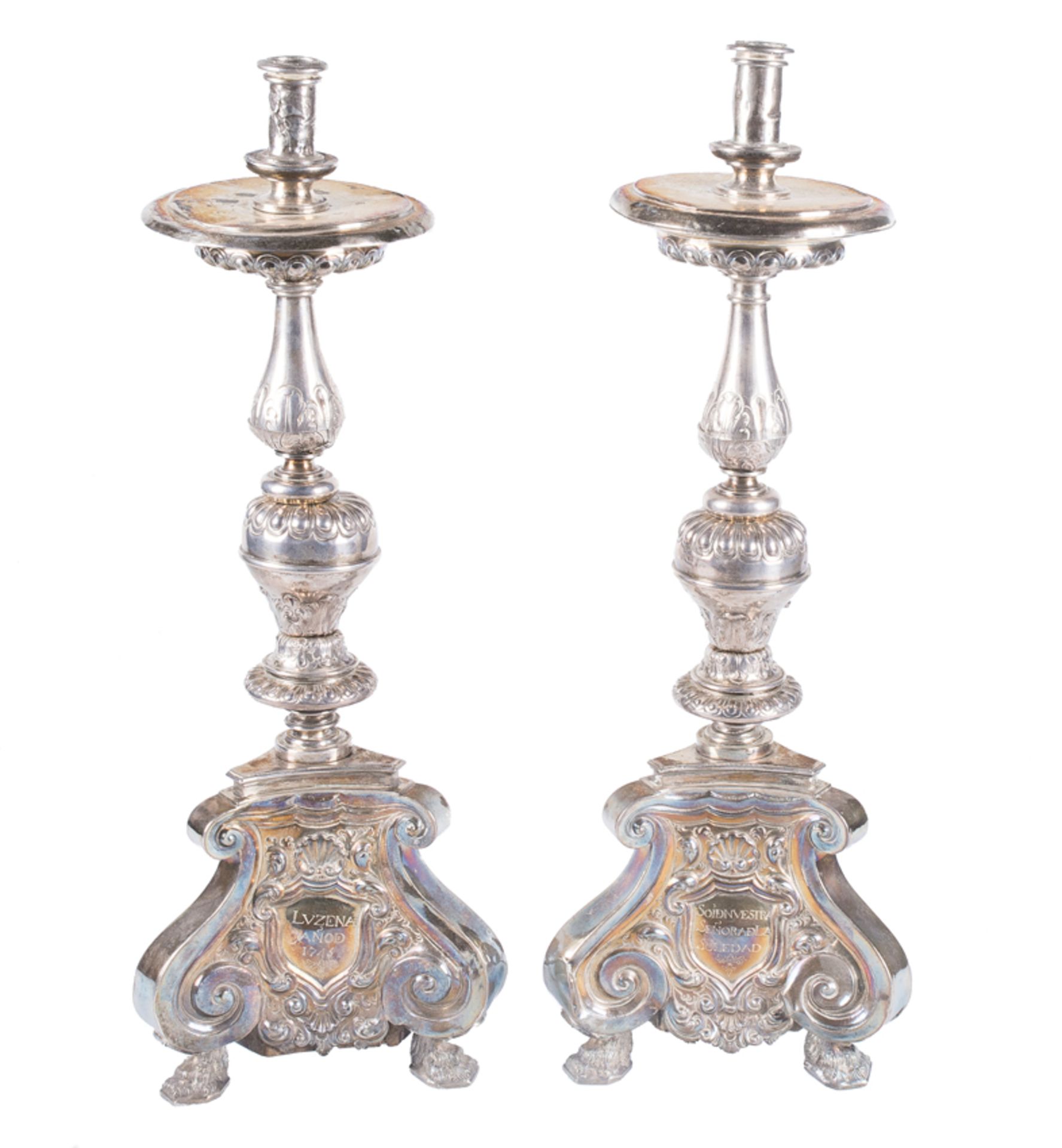 Pair of carved, embossed and chiselled silver candlesticks punched with the &quot;MAS&quot; mark by