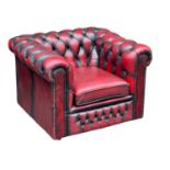 A deep button ox-blood leather club chair.