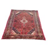 A large vintage Middle Eastern hand knotted rug. 217.5x295.5cm