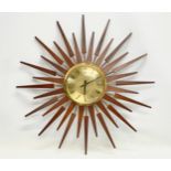 A large 1960’s Mid Century teak sunburst clock by Anstey & Wilson. 62.5cm