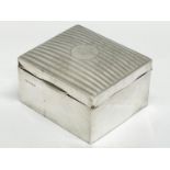 A silver cigarette box. Birmingham. 10.5x9.5x6cm.