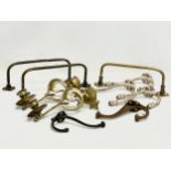 A quantity of 19th and early 20th century brass candleholders, rails and hooks.