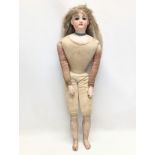 A late 19th / early 20th century Gesland doll with bisque head. 56cm