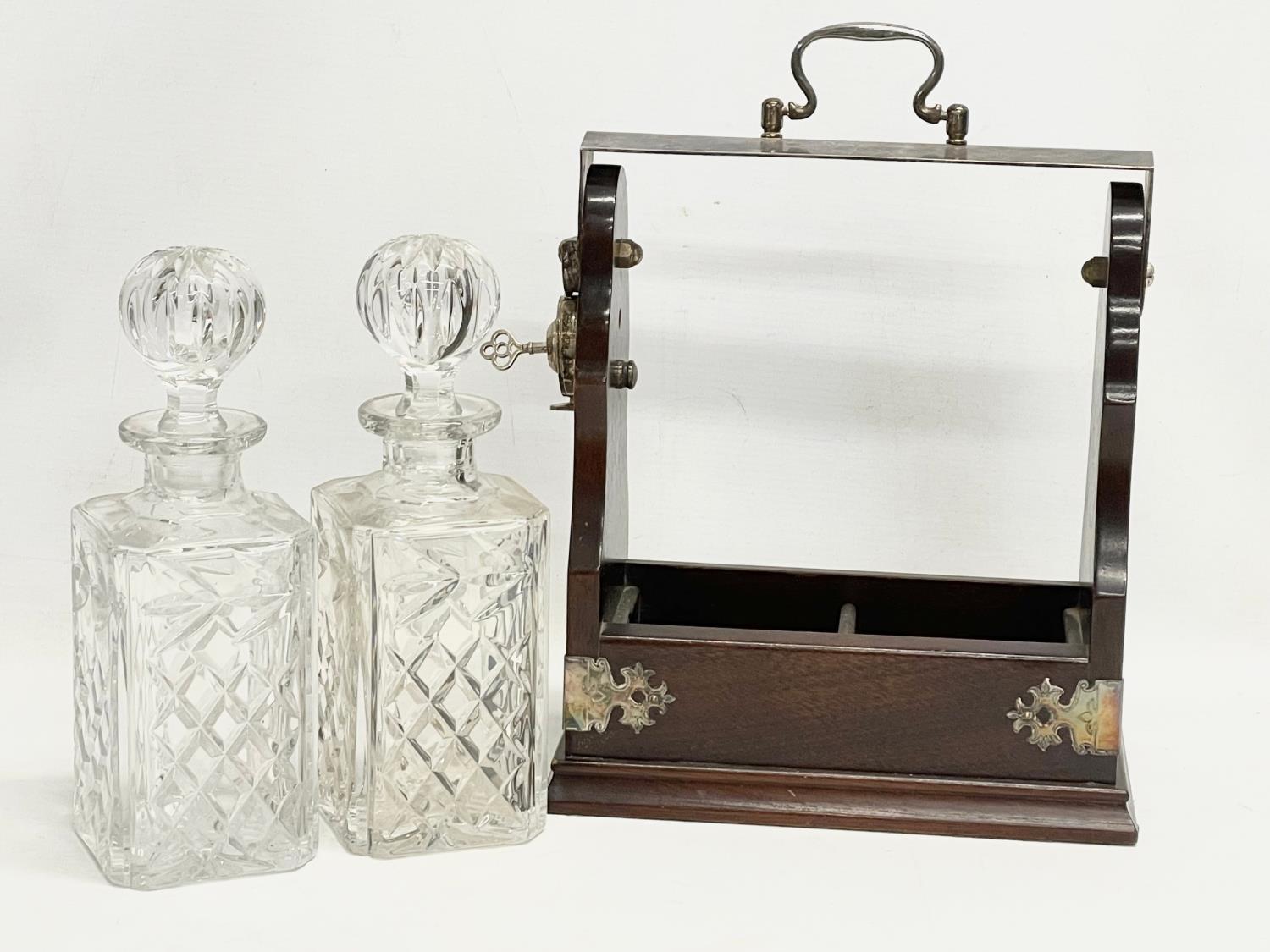 A vintage mahogany and silver plated tantalus with a pair of crystal decanters. 25x13x31cm - Image 2 of 4