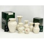A quantity of Belleek Pottery vases and 2 boxes. Largest vase measures 14x21cm.