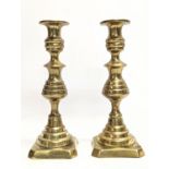 A pair of Victorian brass candlesticks. 24cm