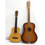 2 accoustic guitars. Largest guitar with case.