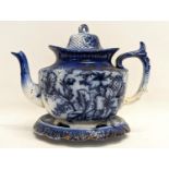 A Victorian pottery teapot on stand. 24x19cm