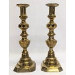 A pair of Victorian brass candlesticks. 28cm