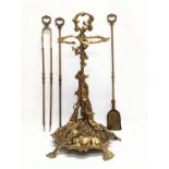 A vintage ornate brass companion set. 56cm