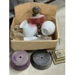 A box of oil lamp shades and parts etc.
