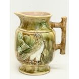 A large late 19th century Majolica pitcher. 20.5x22.5cm