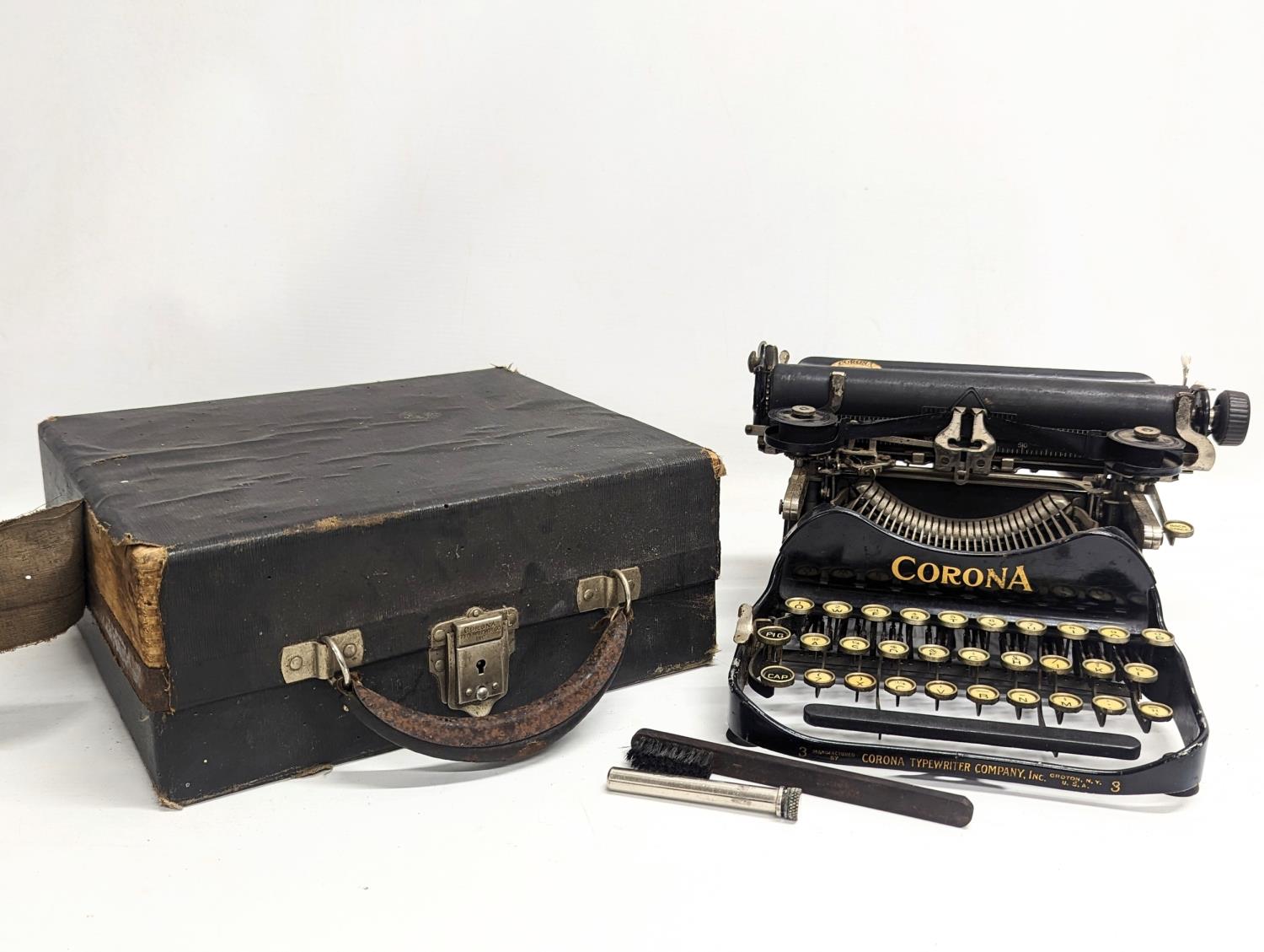 An early 20th century miniature Corona typewriter, dated 1917.
