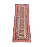 A vintage Middle Eastern hand knotted runner rug. 83x275cm