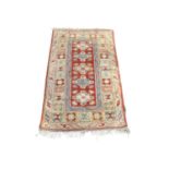 A vintage hand knotted rug. 129x233cm