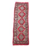 A vintage Middle Eastern hand knotted runner rug 69.5x234cm